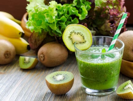 Green smoothie with kiwi, bananas and salad leaves